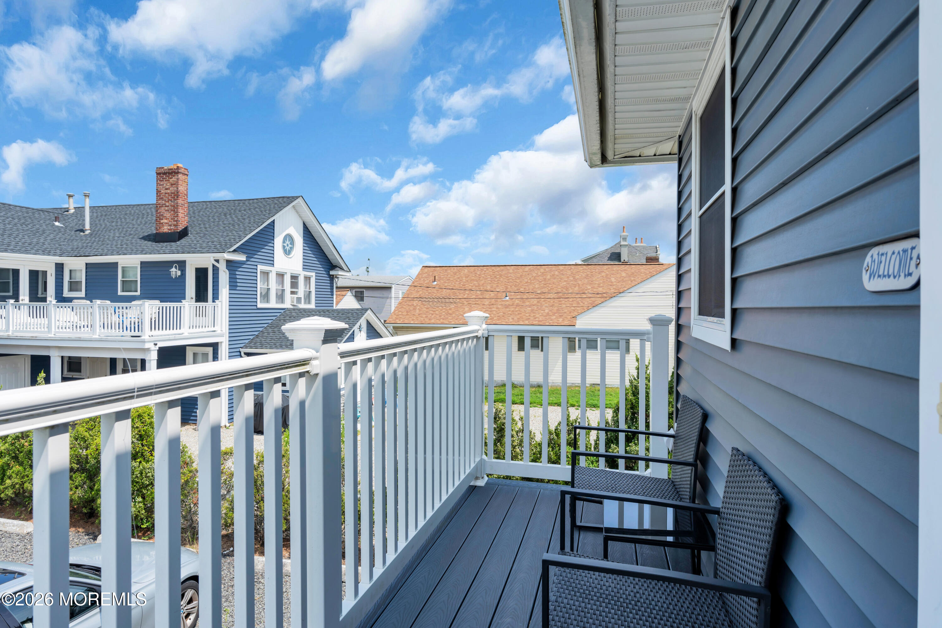 27 Arnold Avenue Point Pleasant Beach, NJ 08742 - Photo 31 of 48 a view of a houses with a balcony and wooden fence