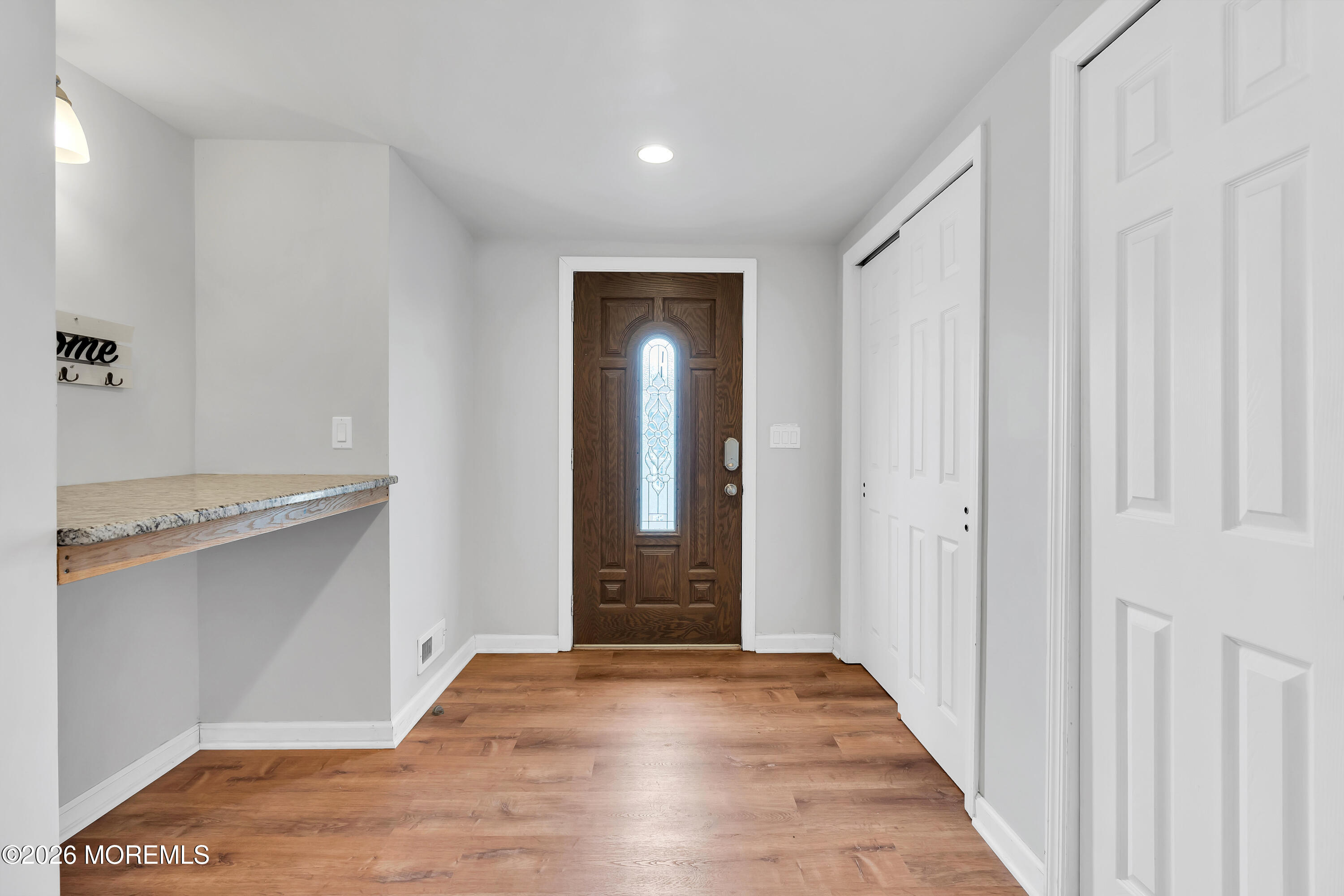 27 Arnold Avenue Point Pleasant Beach, NJ 08742 - Photo 35 of 48 a view of a hallway with wooden floor and staircase