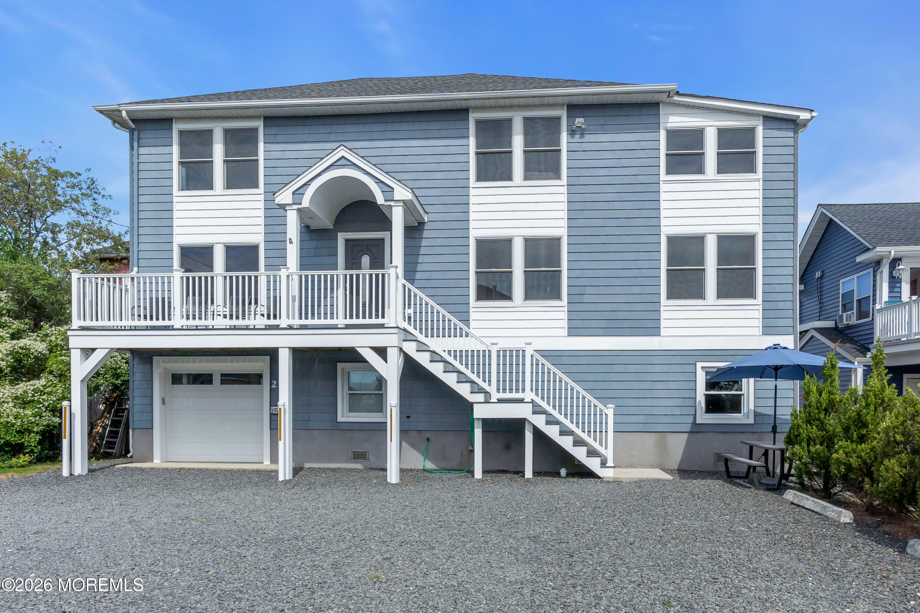 27 Arnold Avenue Point Pleasant Beach, NJ 08742 - Photo 4 of 48 a front view of a house with a balcony and ceiling fan
