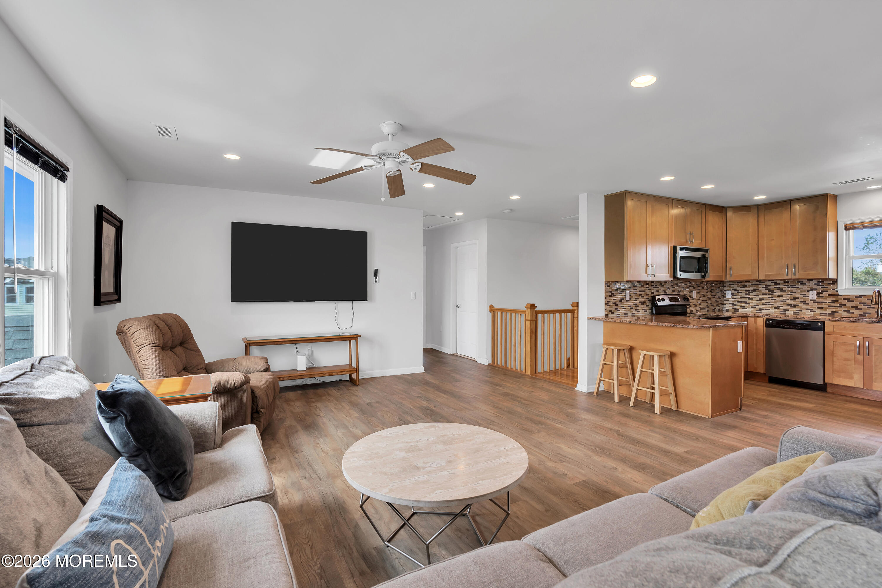 27 Arnold Avenue Point Pleasant Beach, NJ 08742 - Photo 42 of 48 a living room with furniture kitchen view and a flat screen tv
