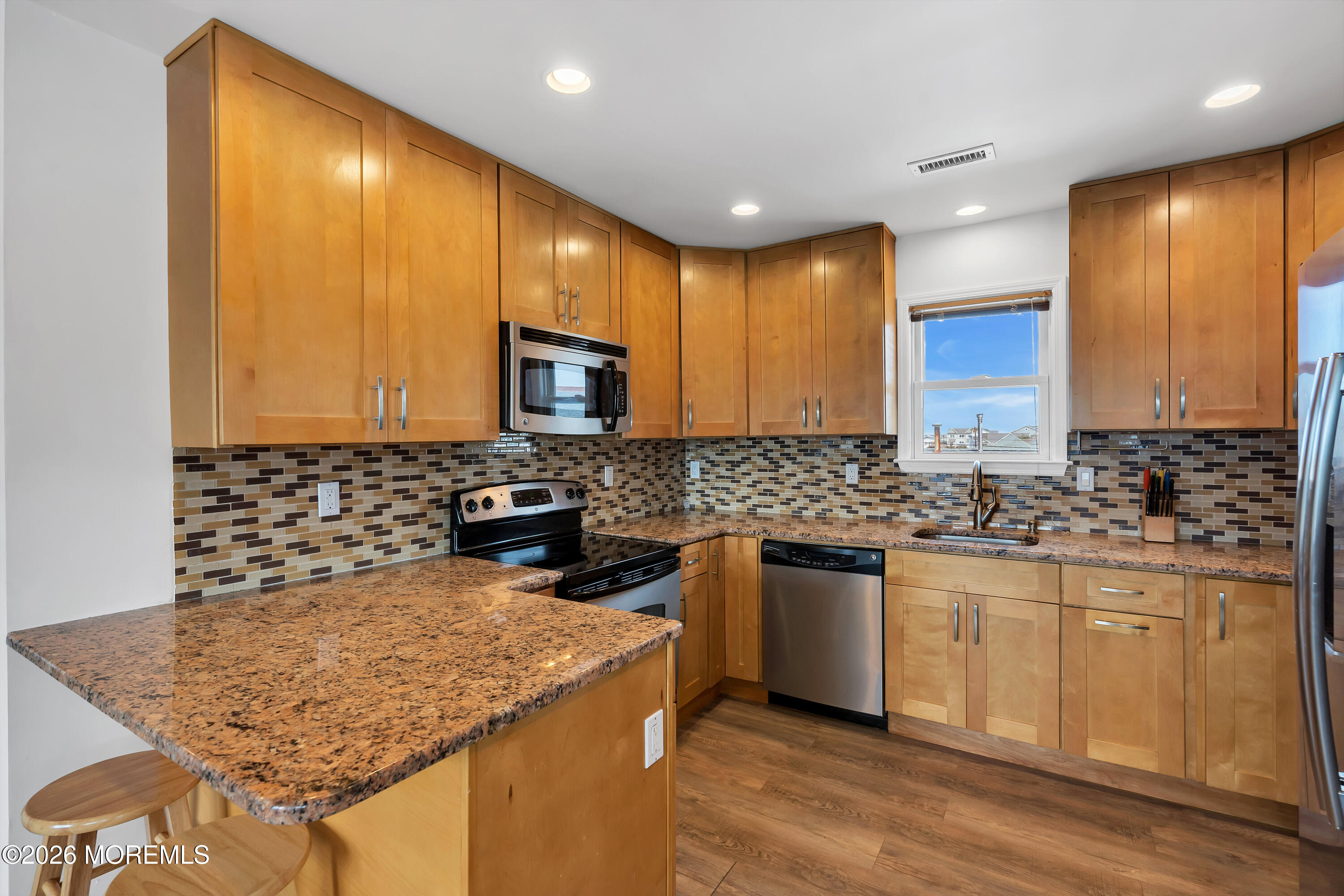 27 Arnold Avenue Point Pleasant Beach, NJ 08742 - Photo 44 of 48 a kitchen with stainless steel appliances granite countertop wooden cabinets and a granite counter tops