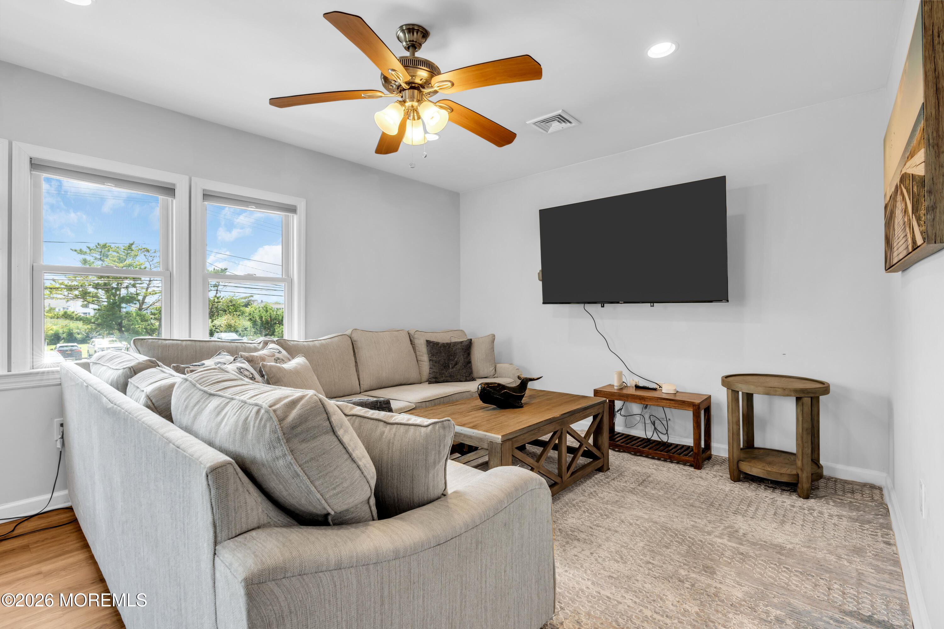 27 Arnold Avenue Point Pleasant Beach, NJ 08742 - Photo 10 of 48 a living room with furniture and a flat screen tv