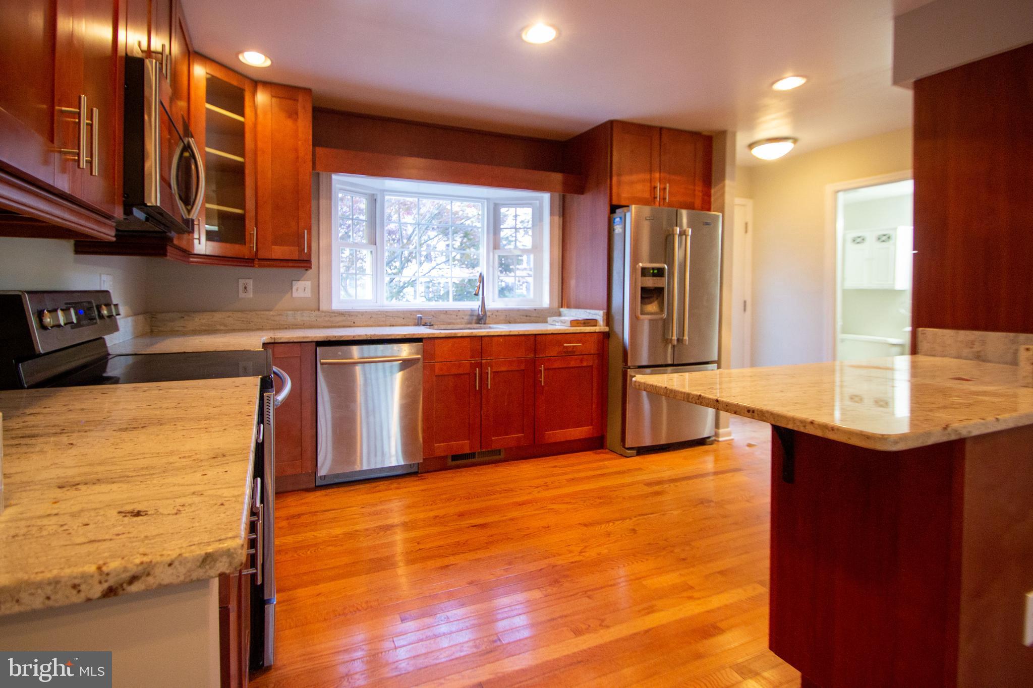 a kitchen with stainless steel appliances granite countertop a sink counter space and cabinets