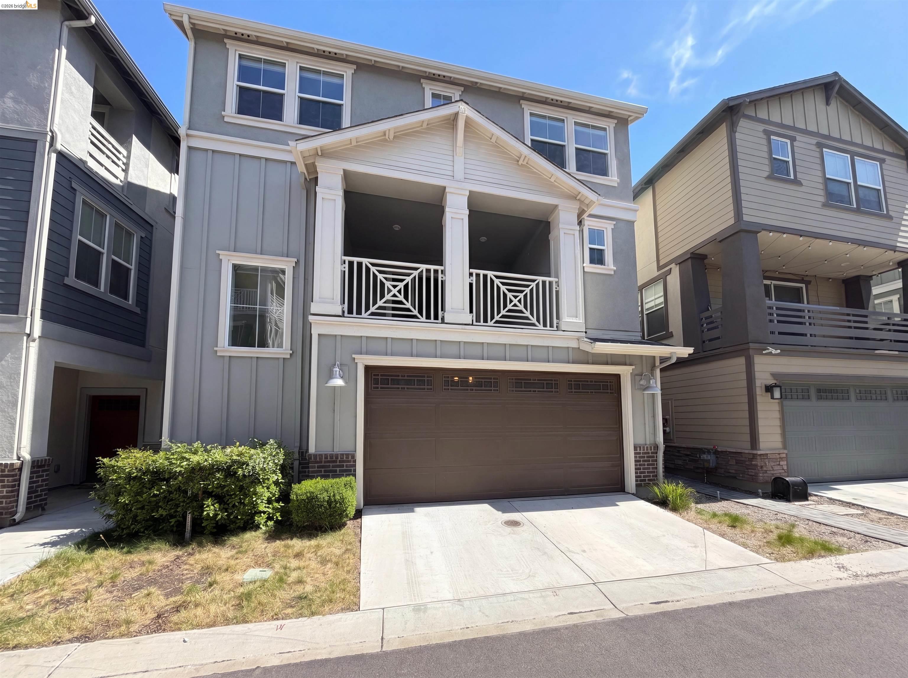 9034 Rudder Way Newark, CA 94560 - Photo 1 of 38 Three-story residence featuring a covered balcony with decorative railing, a two-car garage, and a covered entry with columns