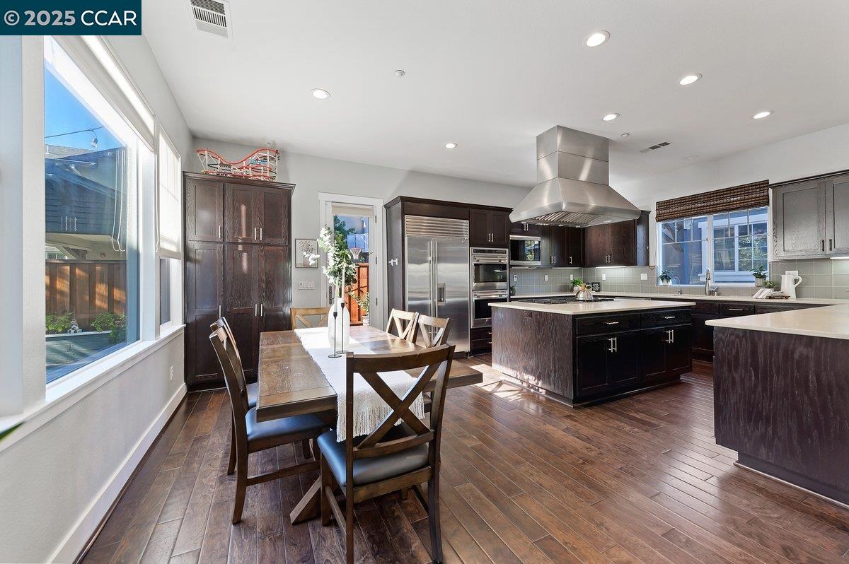 5656 Stockton Loop Livermore, CA 94550 - Photo 13 of 37 a kitchen with a table chairs sink and cabinets