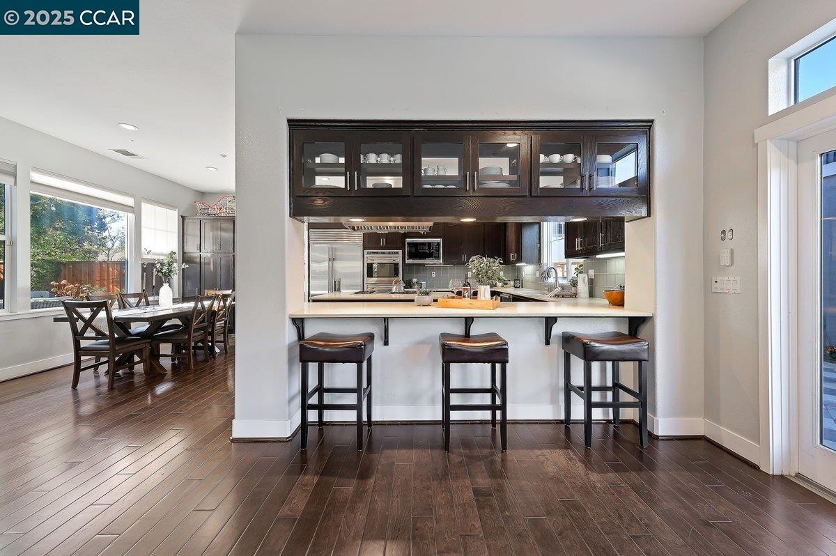 5656 Stockton Loop Livermore, CA 94550 - Photo 18 of 37 a kitchen with a dining table chairs and wooden floor