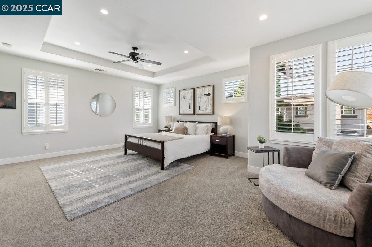 5656 Stockton Loop Livermore, CA 94550 - Photo 23 of 37 a spacious bedroom with a bed and a couch