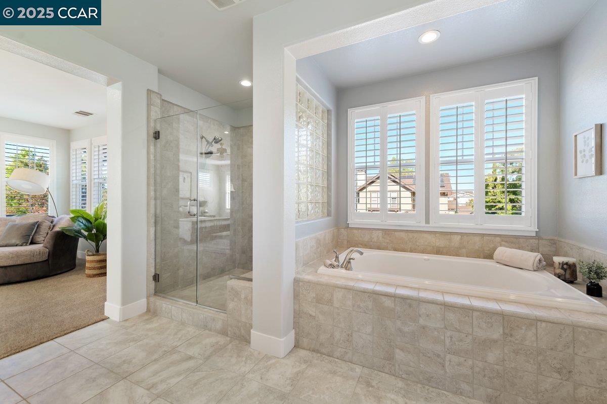 5656 Stockton Loop Livermore, CA 94550 - Photo 25 of 37 a spacious bathroom with a tub shower and windows