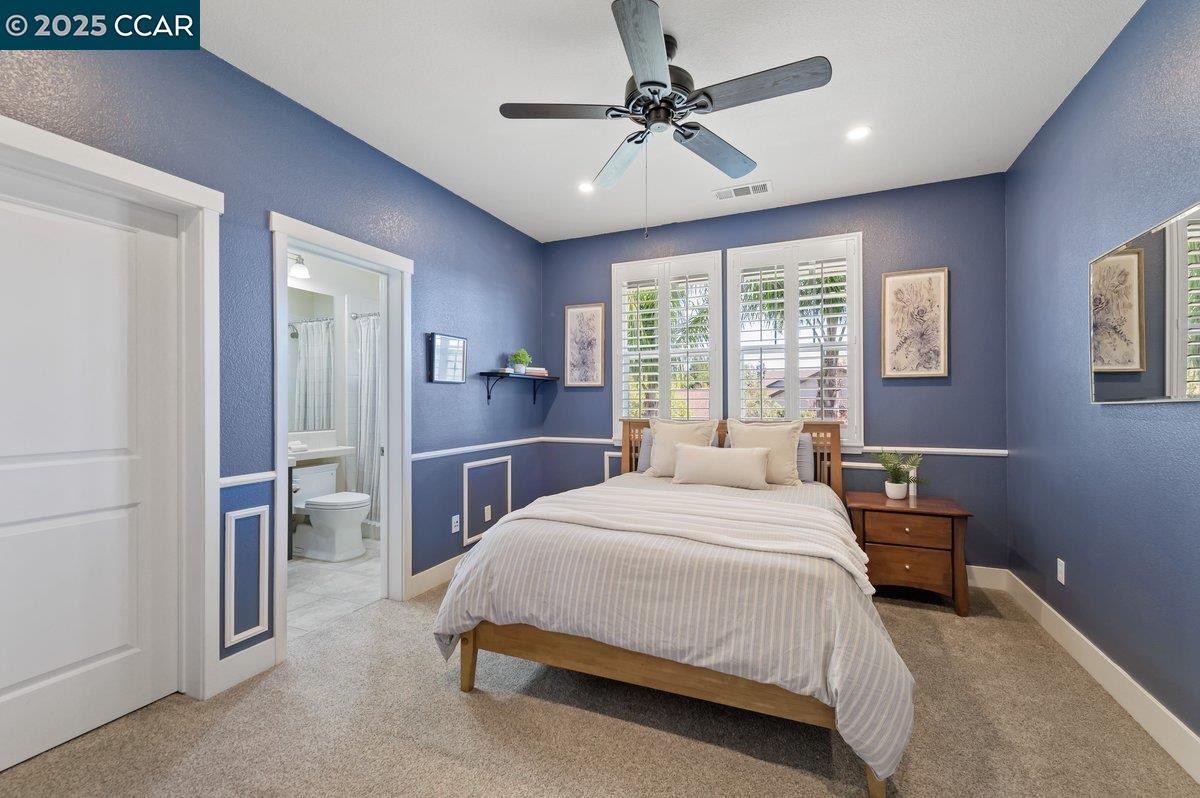 5656 Stockton Loop Livermore, CA 94550 - Photo 27 of 37 a bedroom with a bed a chandelier and a window