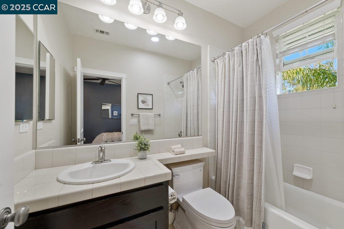 5656 Stockton Loop Livermore, CA 94550 - Photo 29 of 37 a bathroom with a sink vanity mirror and toilet
