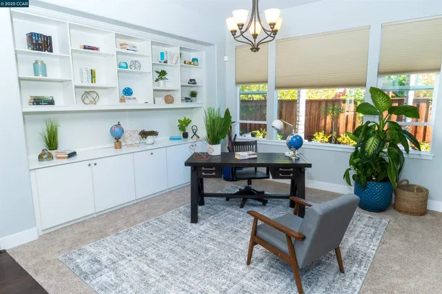 a view of a house with a yard and flower plants