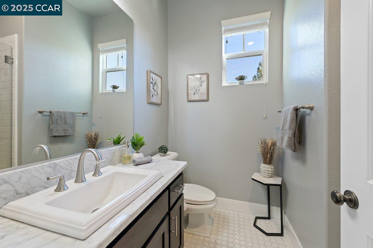 5656 Stockton Loop Livermore, CA 94550 - Photo 9 of 37 a bathroom with a sink toilet and a mirror