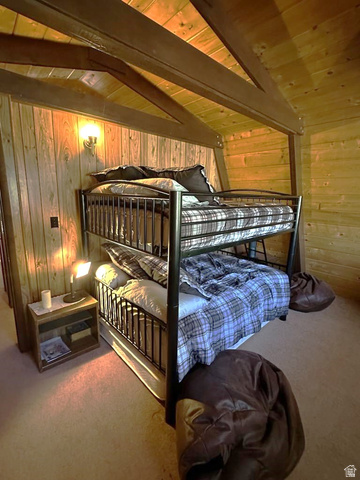 1456 Navajo Road Coalville, UT 84017 - Photo 31 of 55 Bedroom featuring light carpet, wooden walls, vaulted ceiling with beams, and wooden ceiling