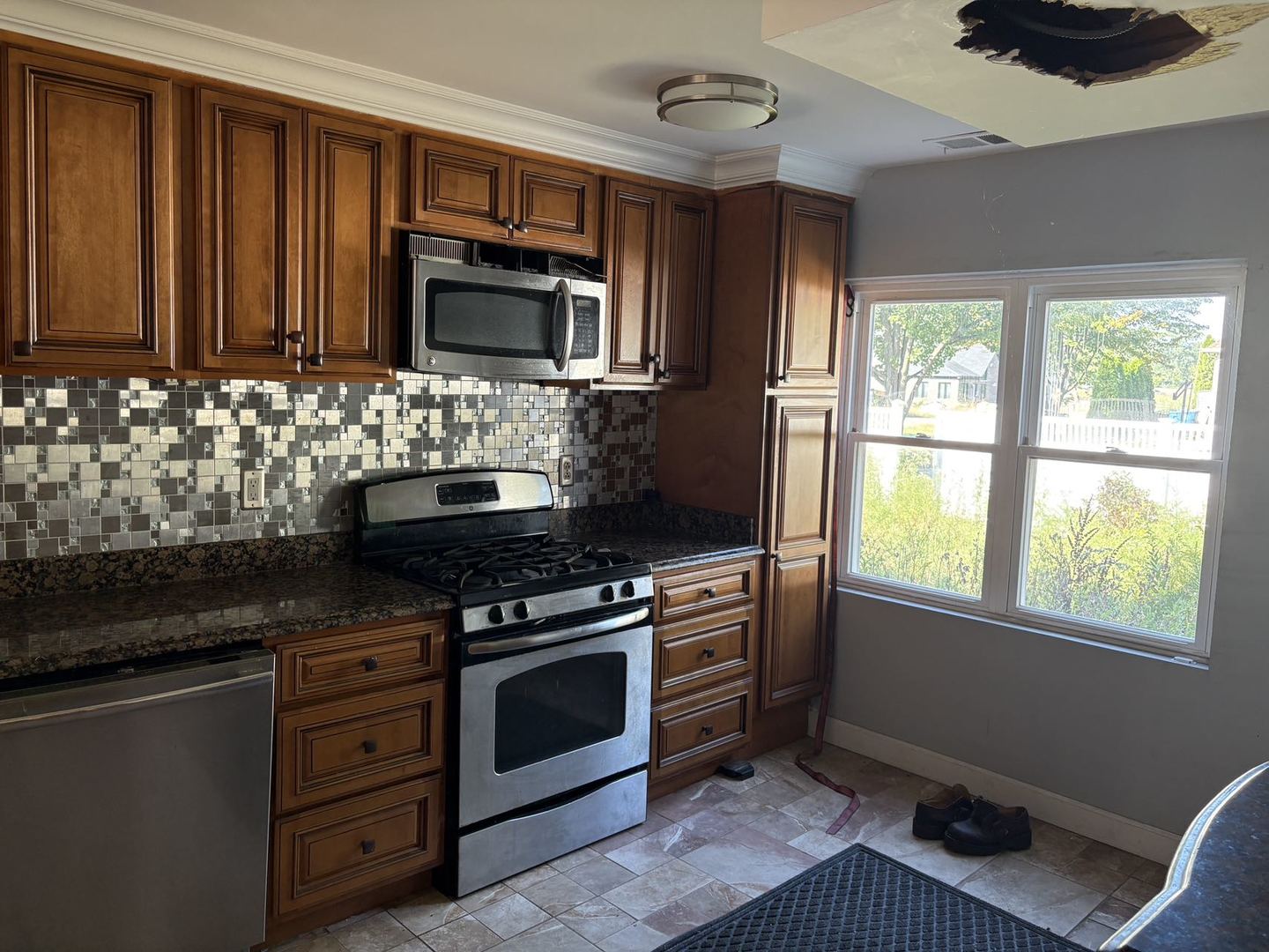 3N750 South Wood Dale Road Addison, IL 60101 - Photo 5 of 5 a kitchen with granite countertop a stove and a microwave