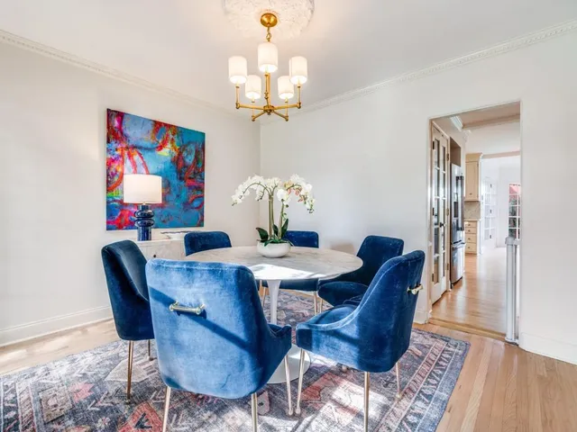 a view of a dining room with furniture wooden floor and a chandelier