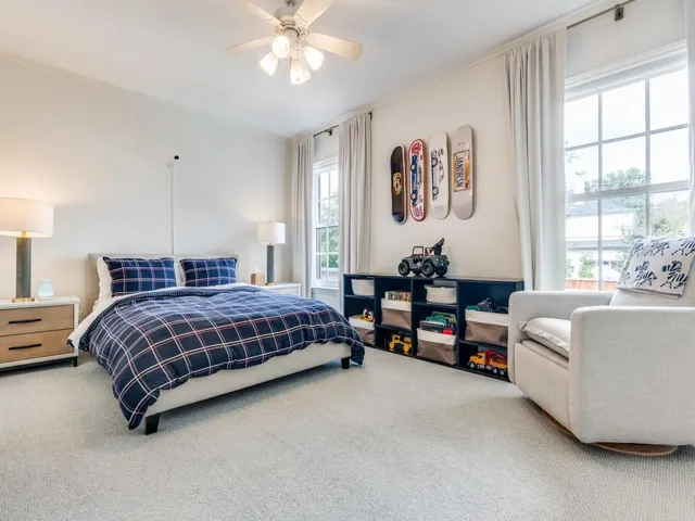a bedroom with a bed couch and a window