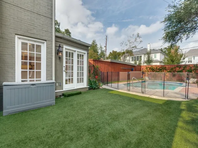 a view of a backyard with a garden and entertaining space