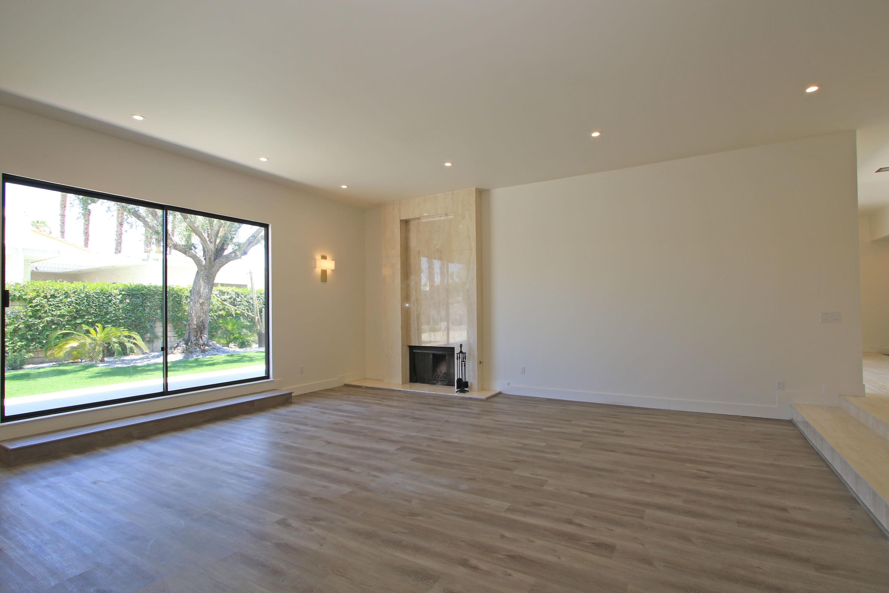 87 Magdalena Drive Rancho Mirage, CA 92270 - Photo 12 of 64 a view of an empty room with wooden floor and a window