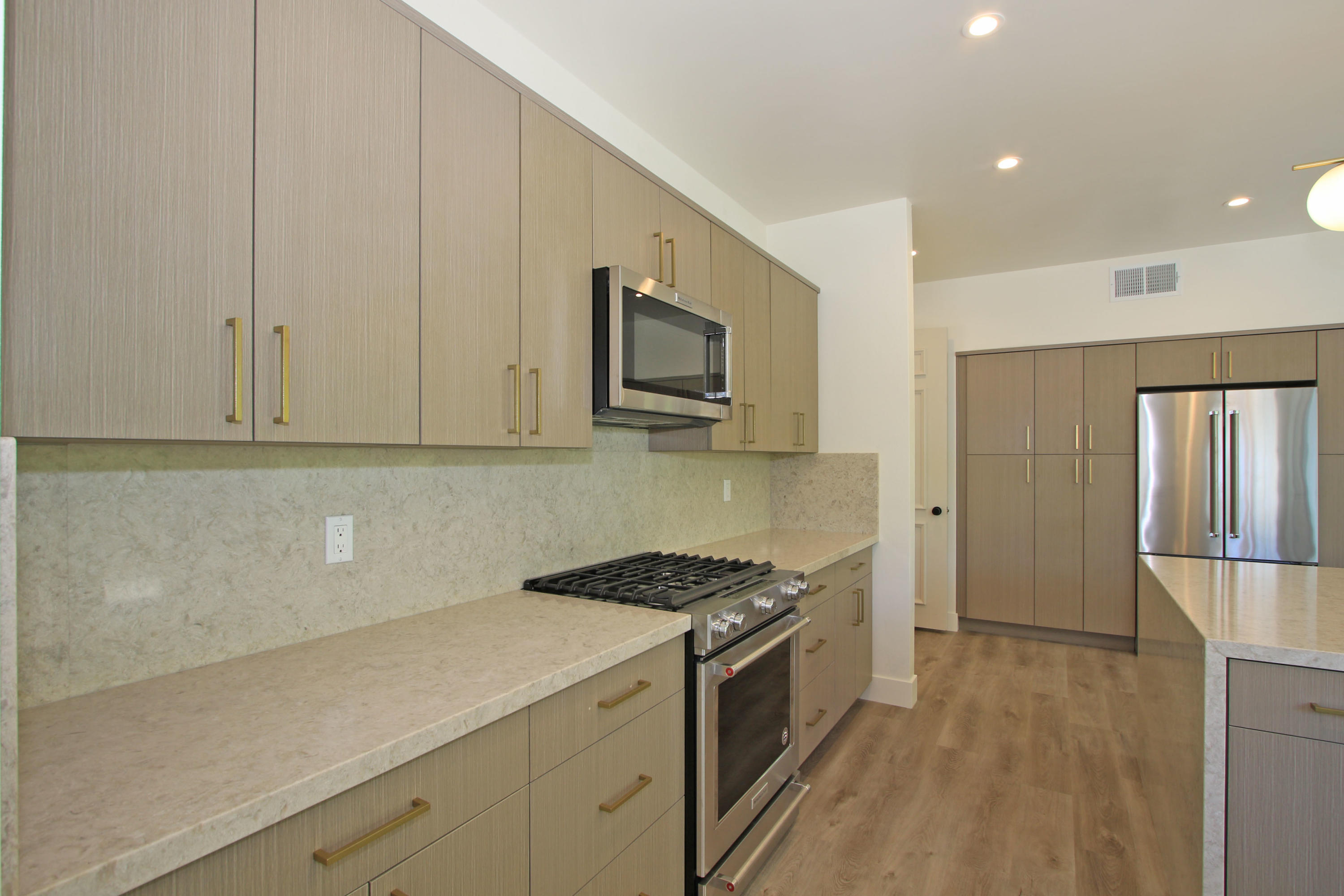 87 Magdalena Drive Rancho Mirage, CA 92270 - Photo 13 of 64 a kitchen with stainless steel appliances white cabinets and a stove