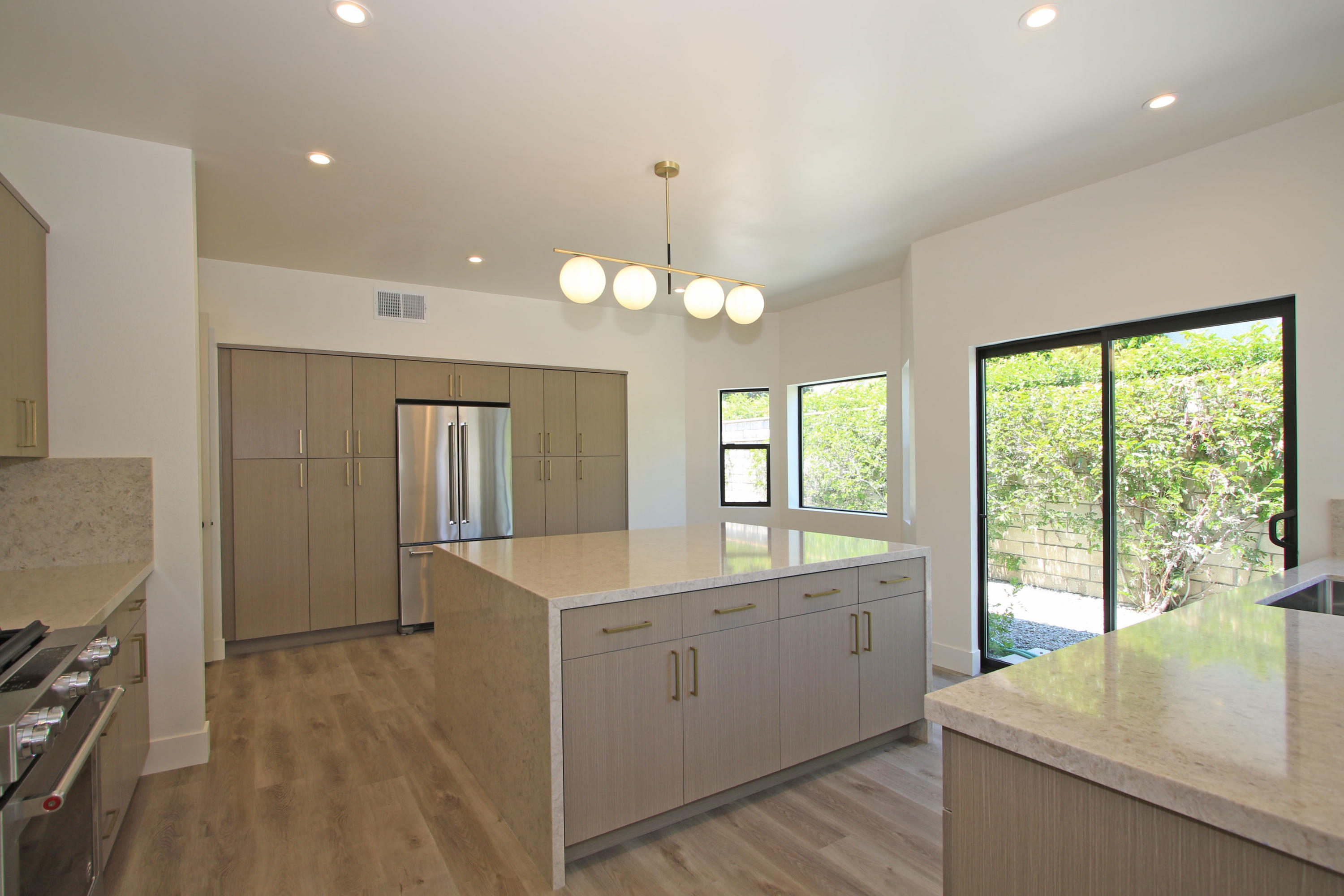 87 Magdalena Drive Rancho Mirage, CA 92270 - Photo 14 of 64 a view of a kitchen with a sink dishwasher and wooden floor