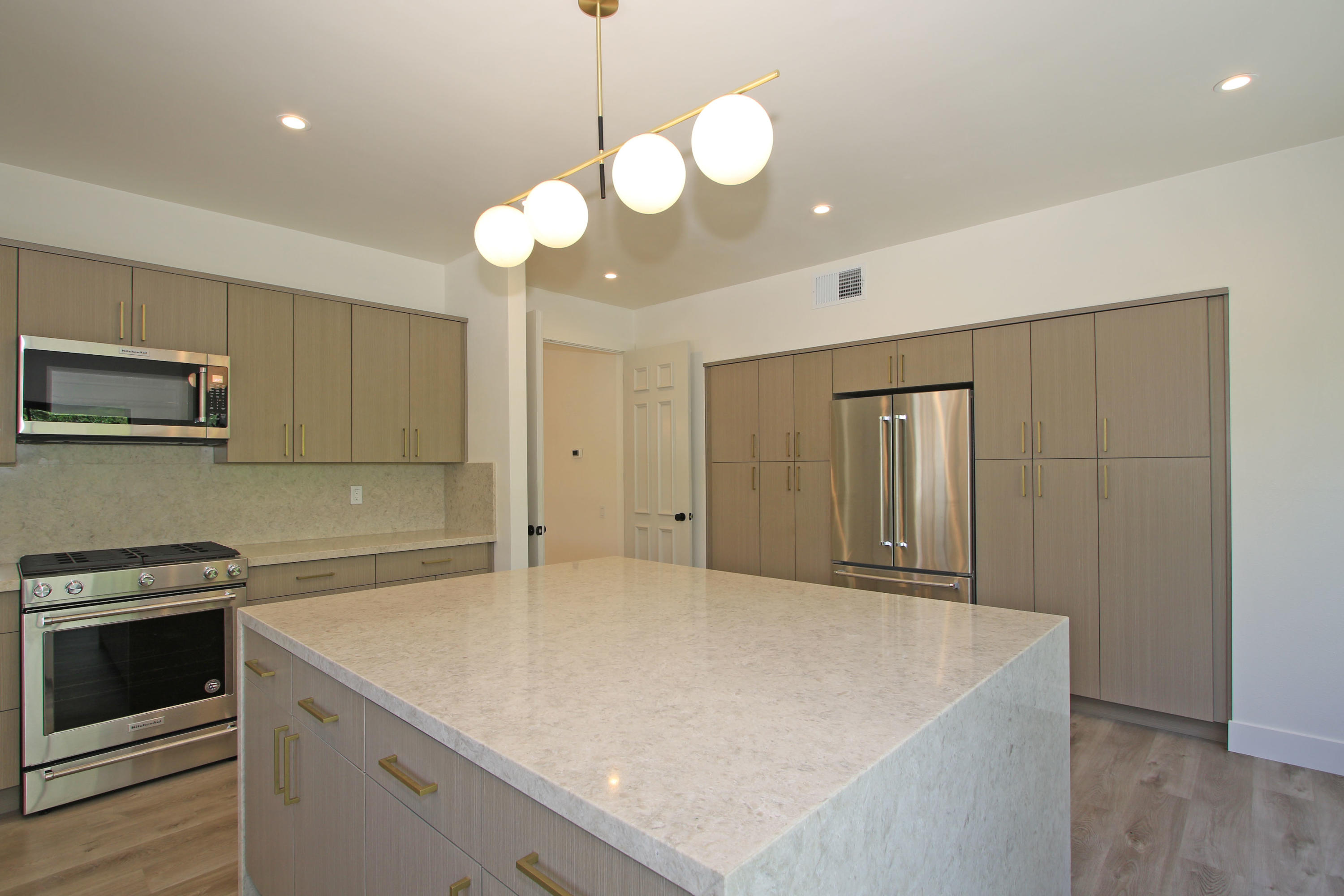 87 Magdalena Drive Rancho Mirage, CA 92270 - Photo 15 of 64 a view of a kitchen with a sink and stainless steel appliances