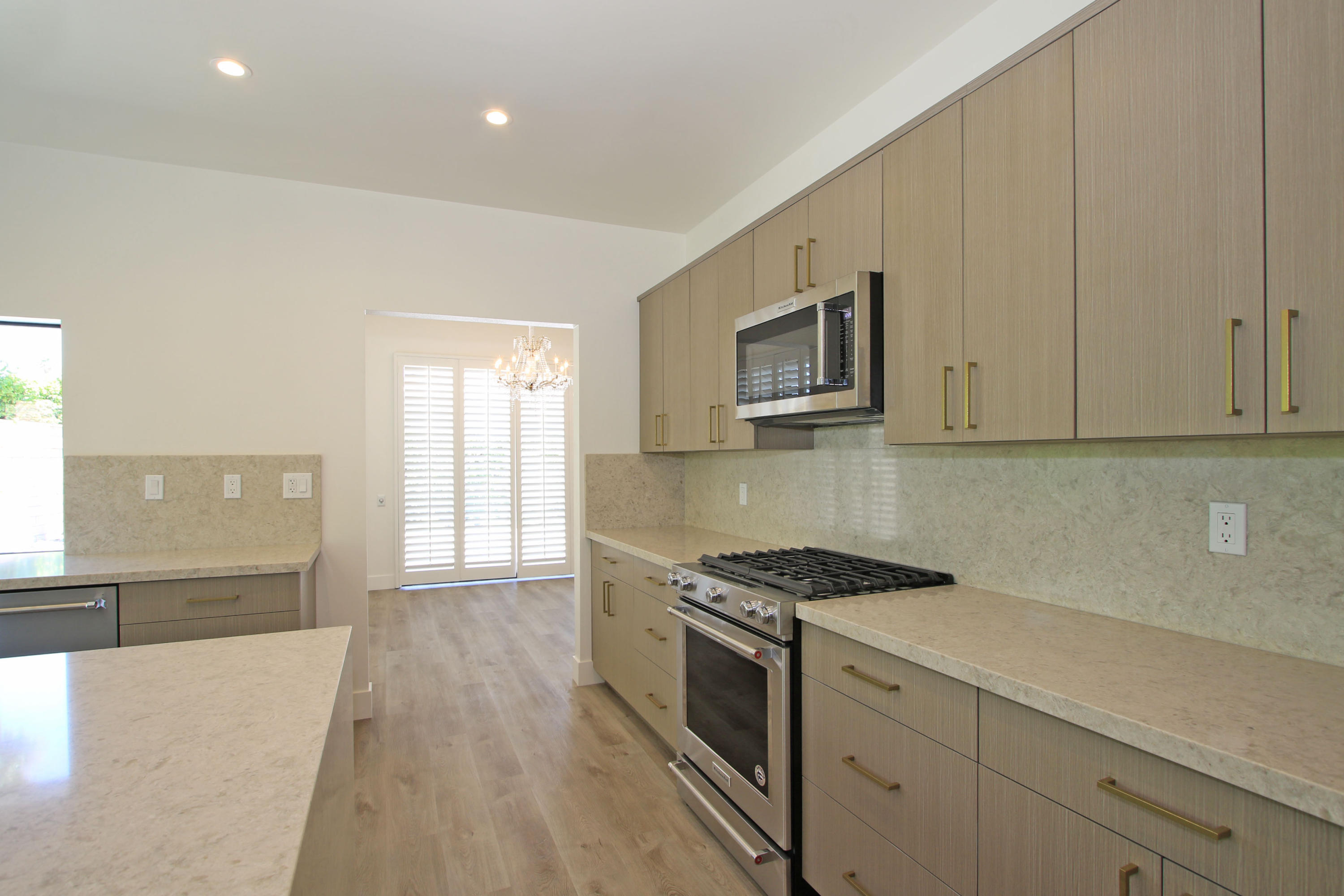 87 Magdalena Drive Rancho Mirage, CA 92270 - Photo 18 of 64 a kitchen with stainless steel appliances granite countertop a stove a sink and a microwave