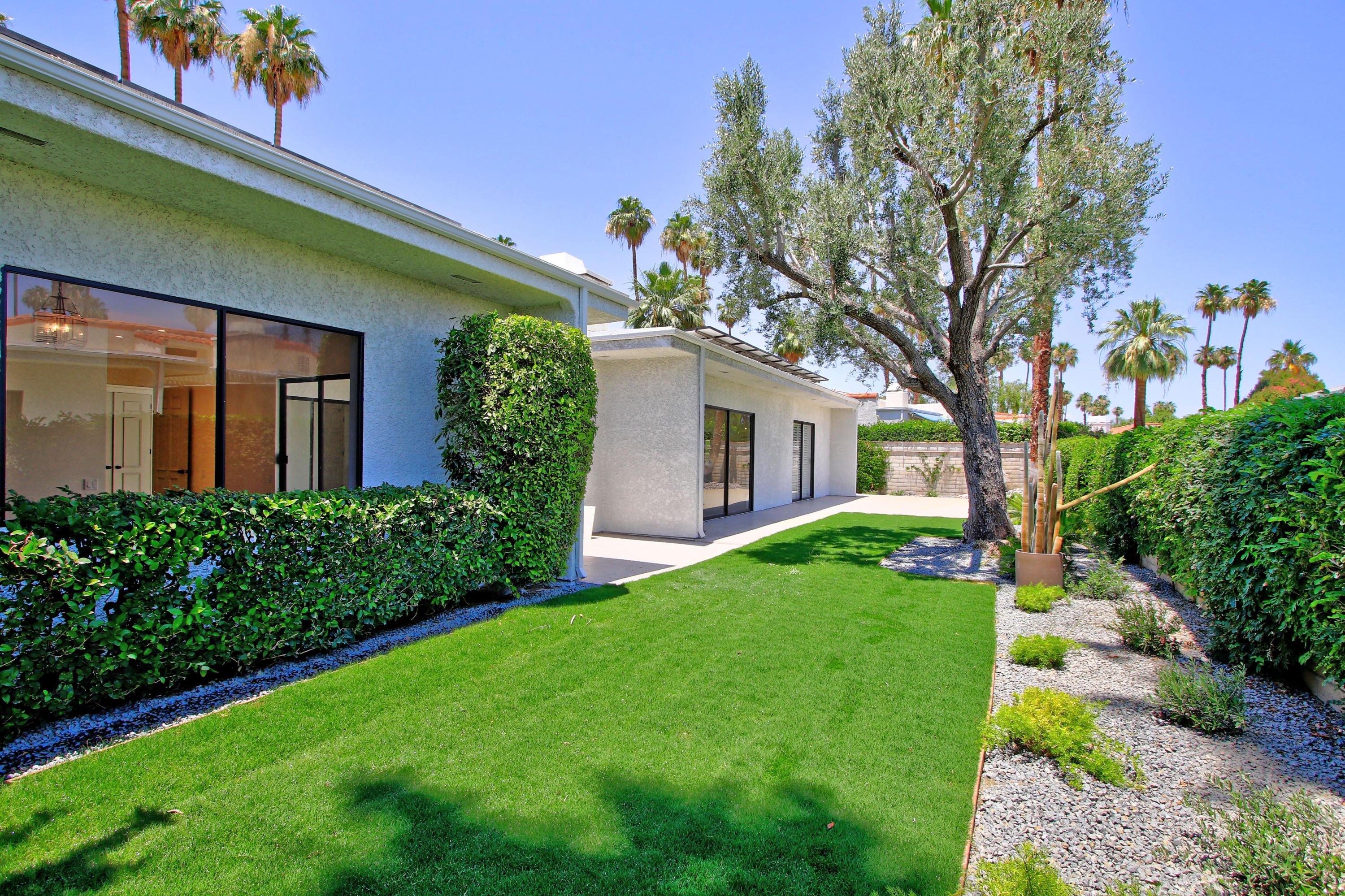 87 Magdalena Drive Rancho Mirage, CA 92270 - Photo 3 of 64 a front view of a house with garden