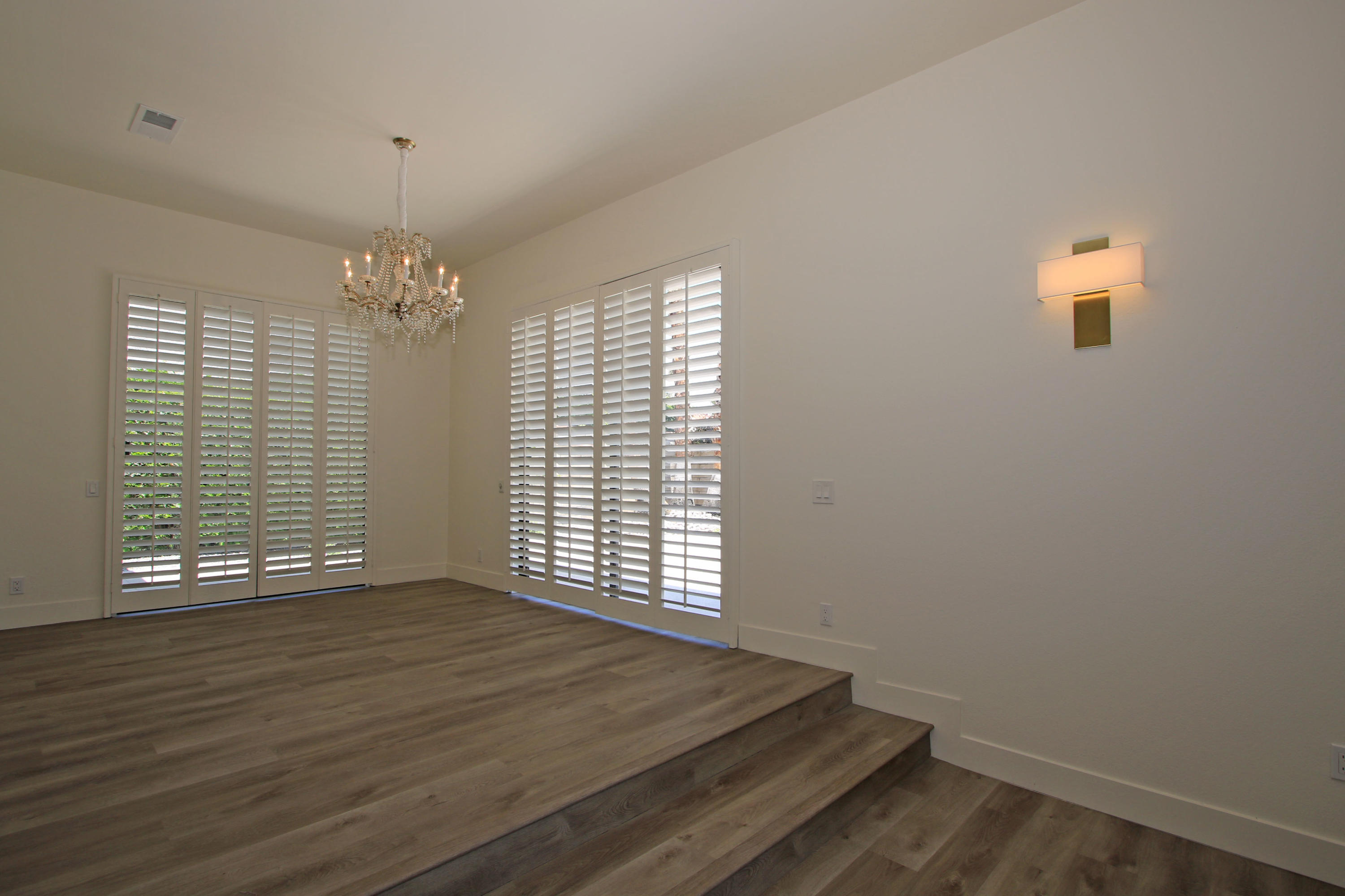 87 Magdalena Drive Rancho Mirage, CA 92270 - Photo 23 of 64 an empty room with wooden floor and windows