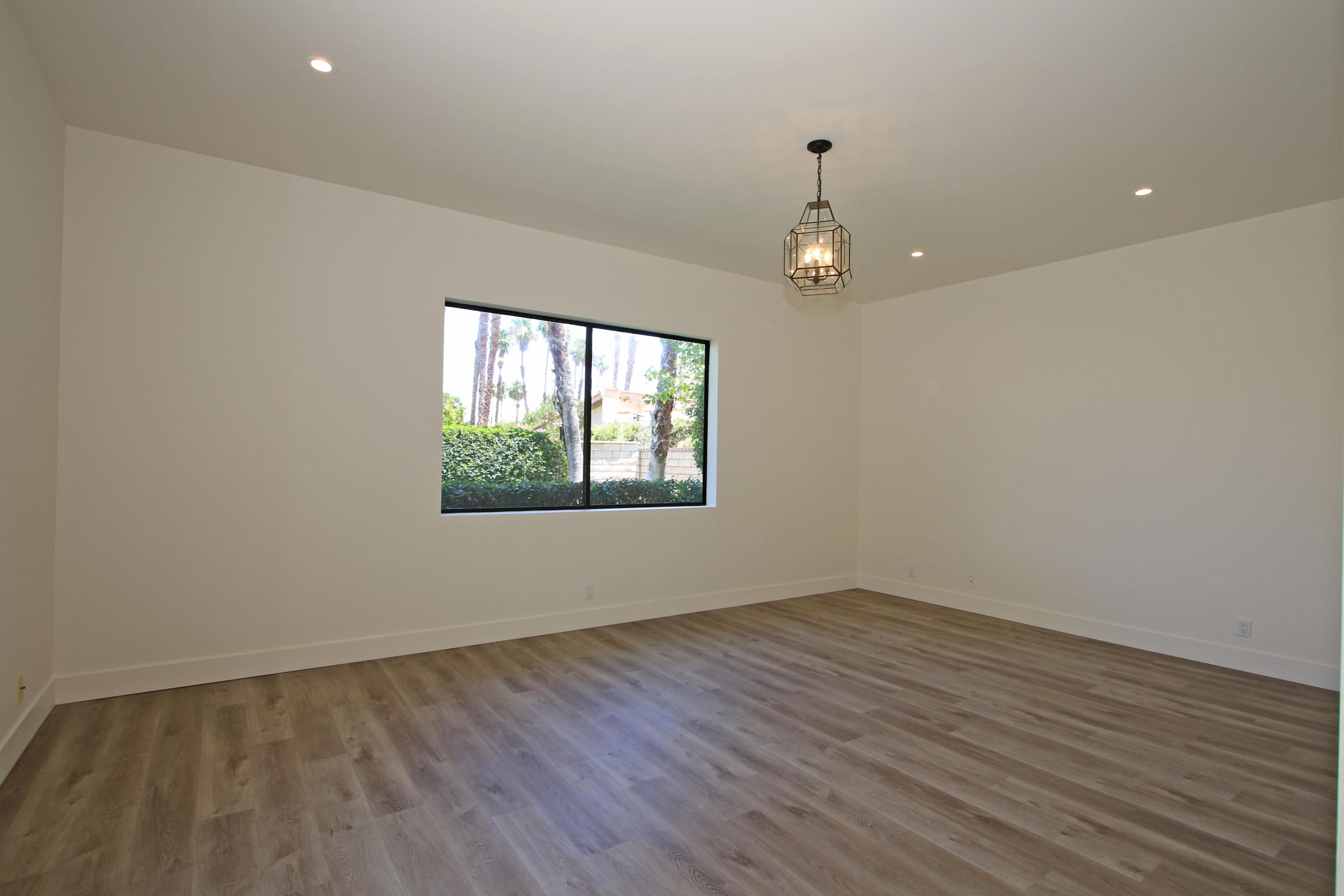 87 Magdalena Drive Rancho Mirage, CA 92270 - Photo 26 of 64 wooden floor in an empty room with a window