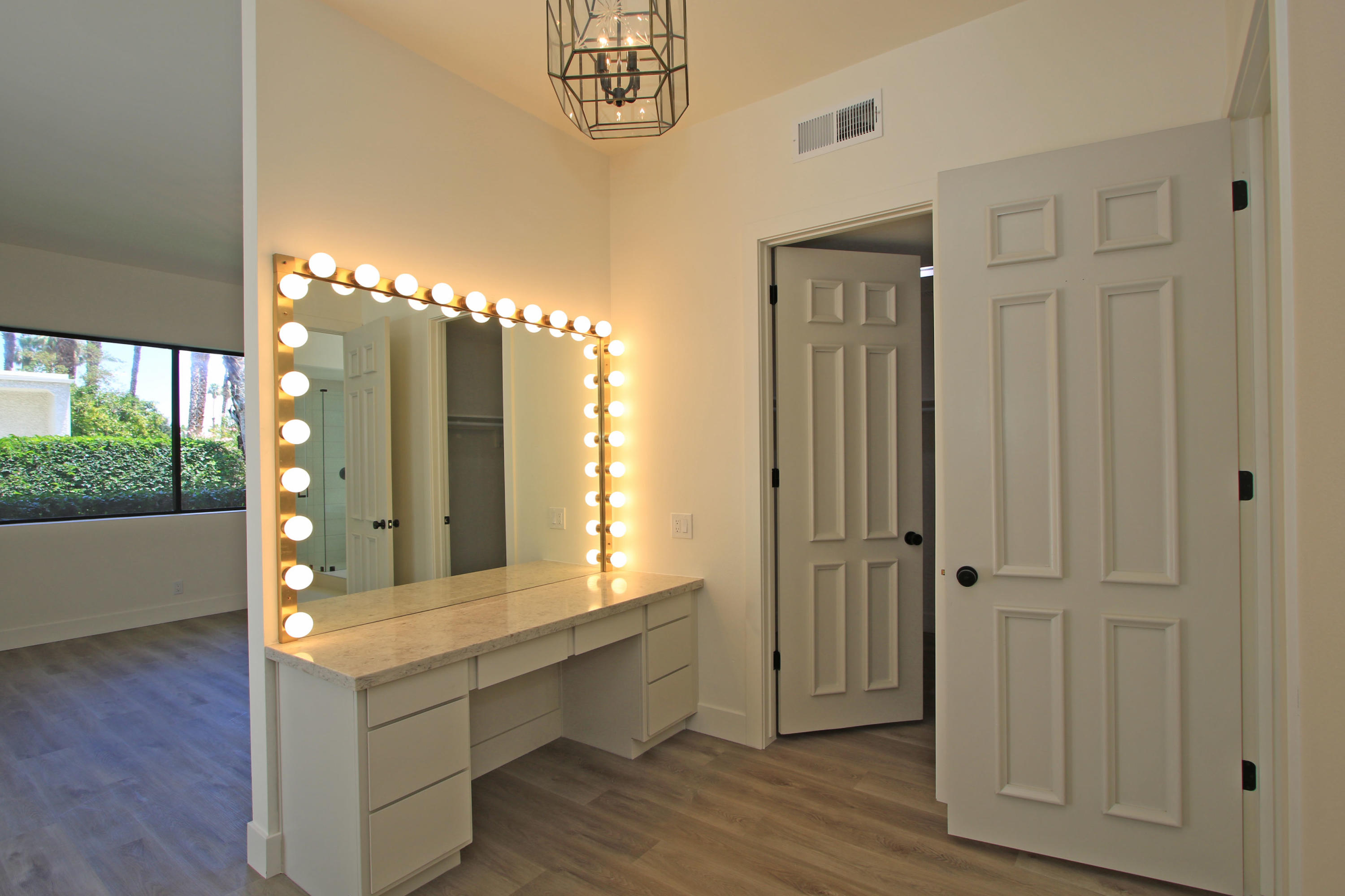 87 Magdalena Drive Rancho Mirage, CA 92270 - Photo 31 of 64 a bathroom with a double vanity sink and a mirror