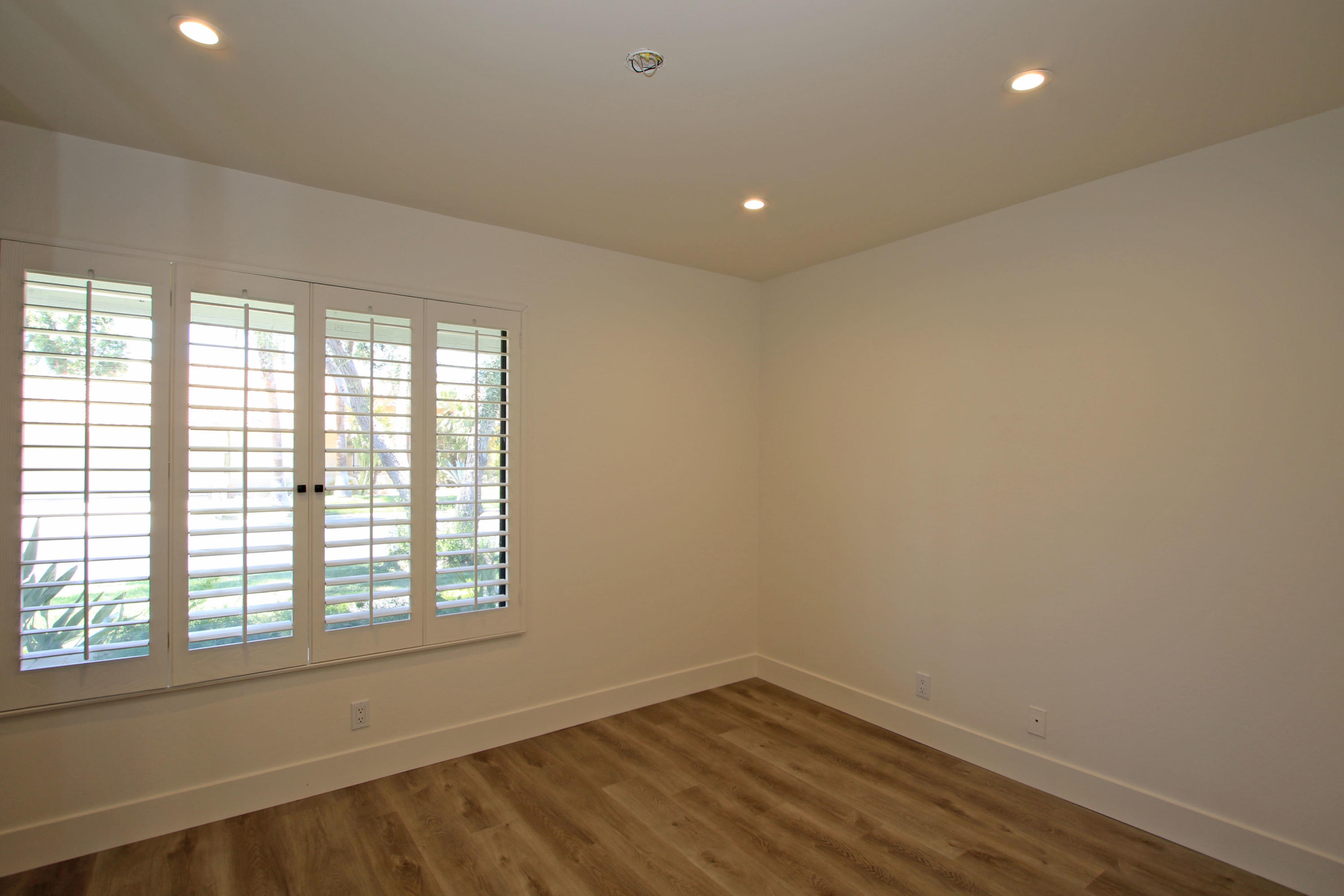 87 Magdalena Drive Rancho Mirage, CA 92270 - Photo 35 of 64 a view of an empty room with wooden floor and a window