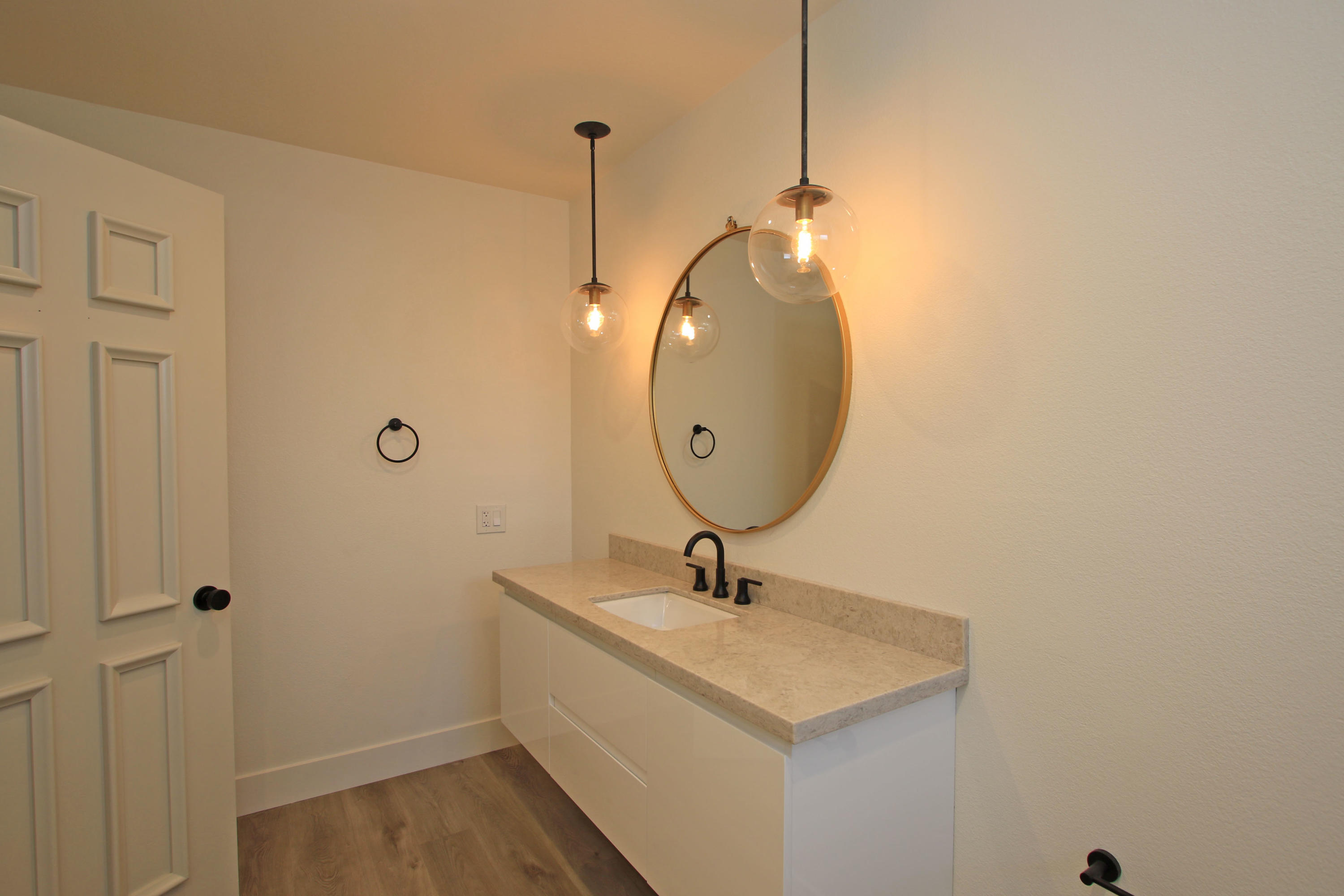 87 Magdalena Drive Rancho Mirage, CA 92270 - Photo 37 of 64 a bathroom with a sink a light fixture and a mirror