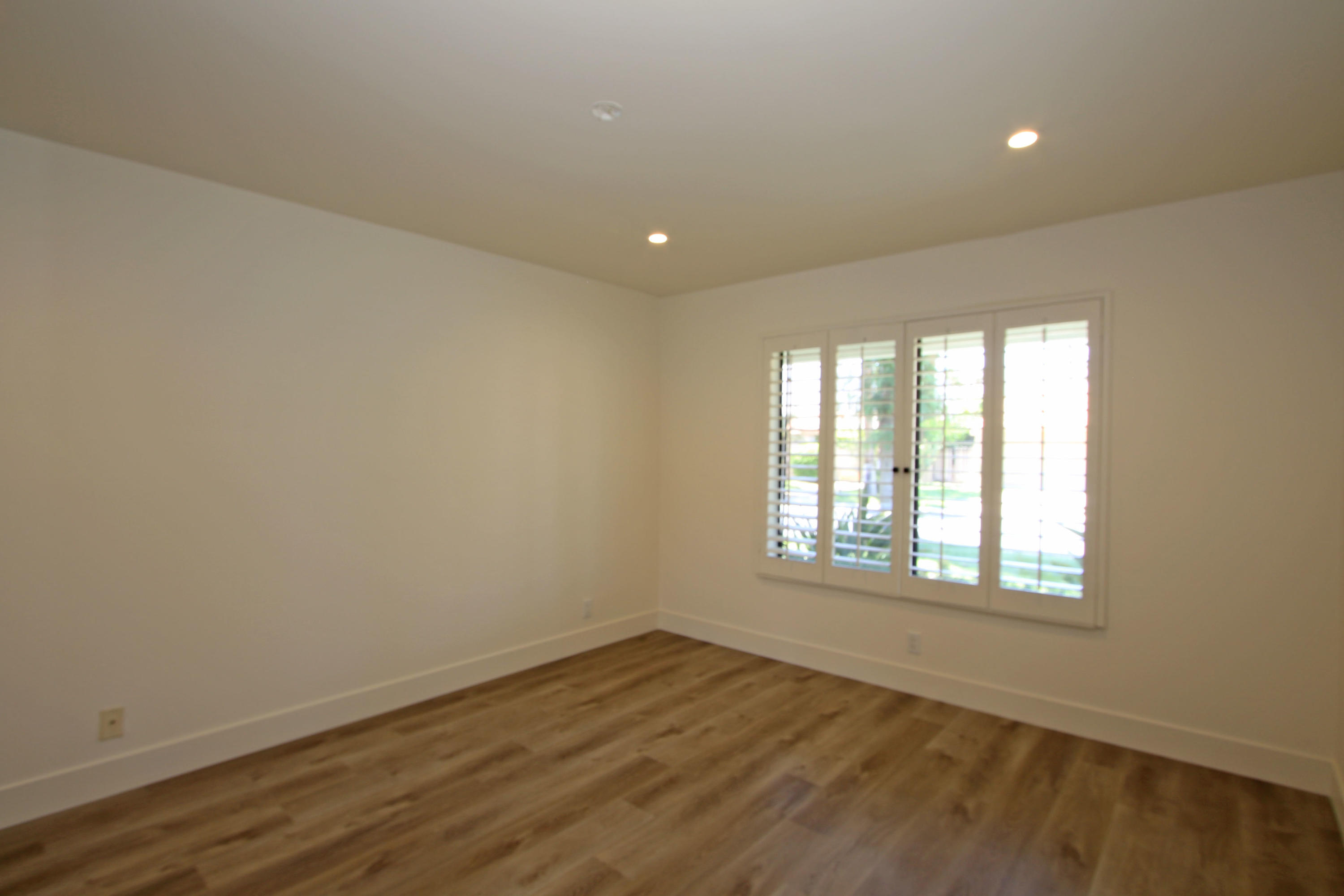 87 Magdalena Drive Rancho Mirage, CA 92270 - Photo 39 of 64 an empty room with wooden floor and windows