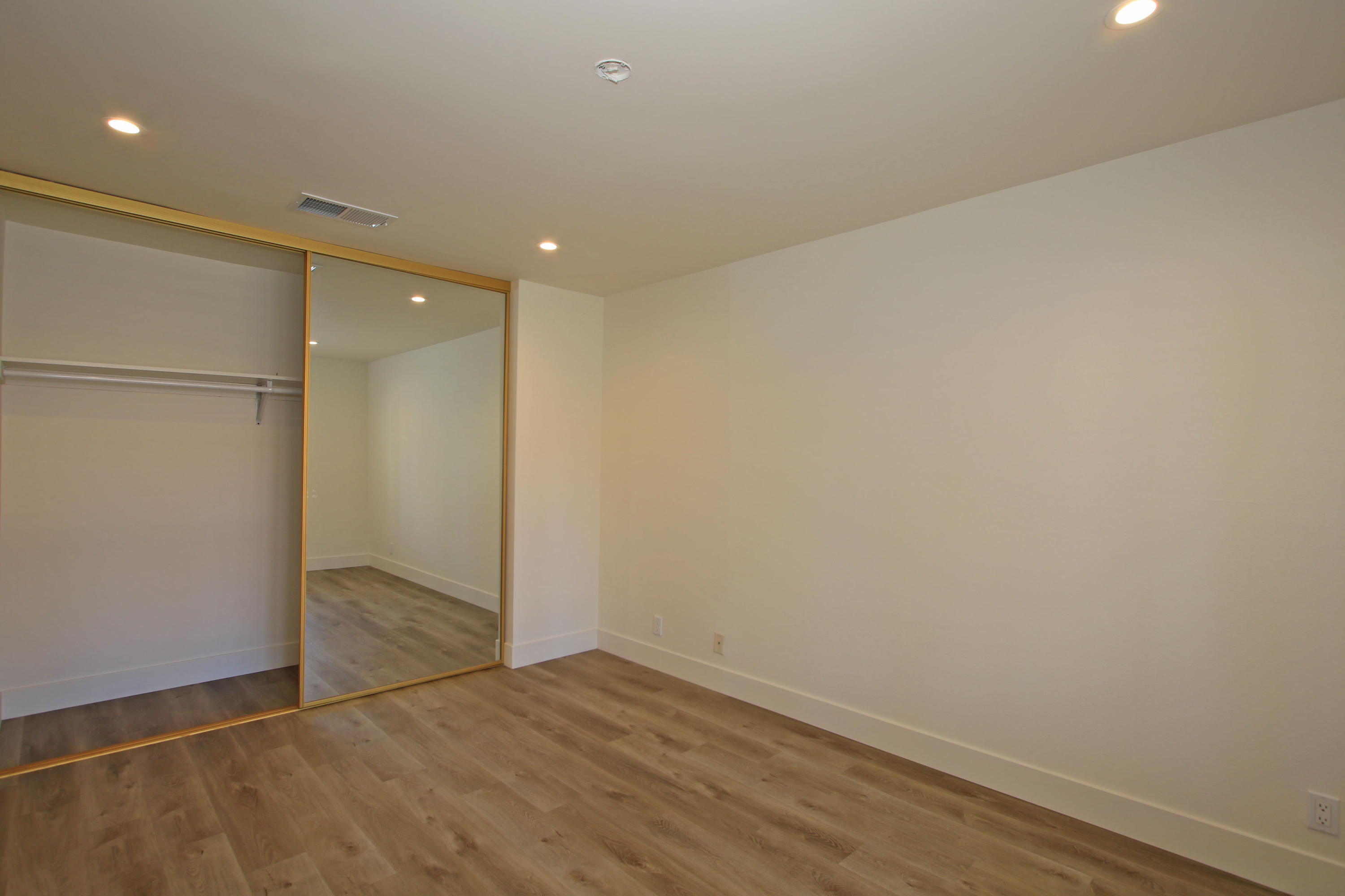 87 Magdalena Drive Rancho Mirage, CA 92270 - Photo 40 of 64 an empty room with wooden floor and sliding door