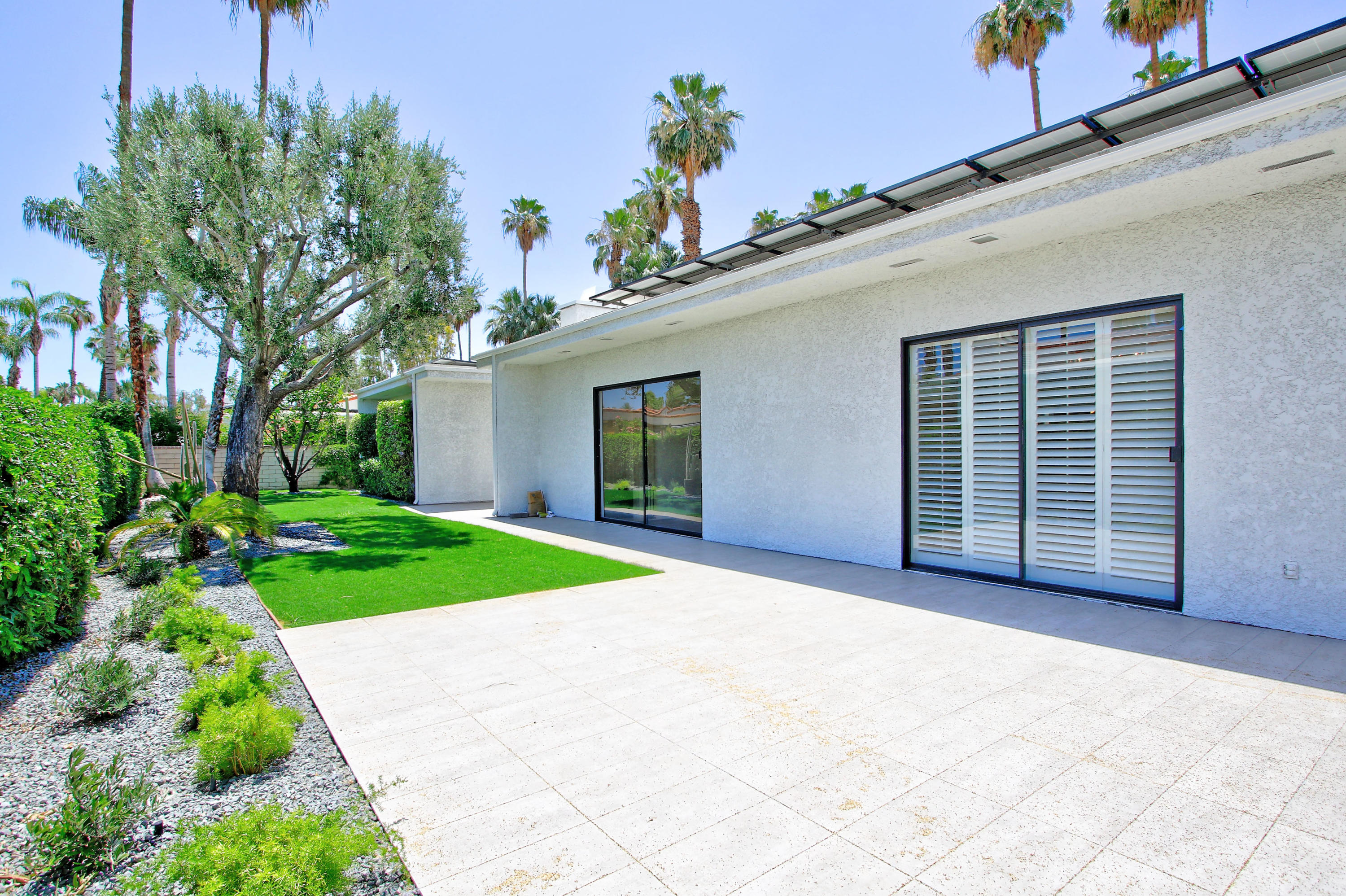 87 Magdalena Drive Rancho Mirage, CA 92270 - Photo 44 of 64 a view of a house with a yard and potted plants