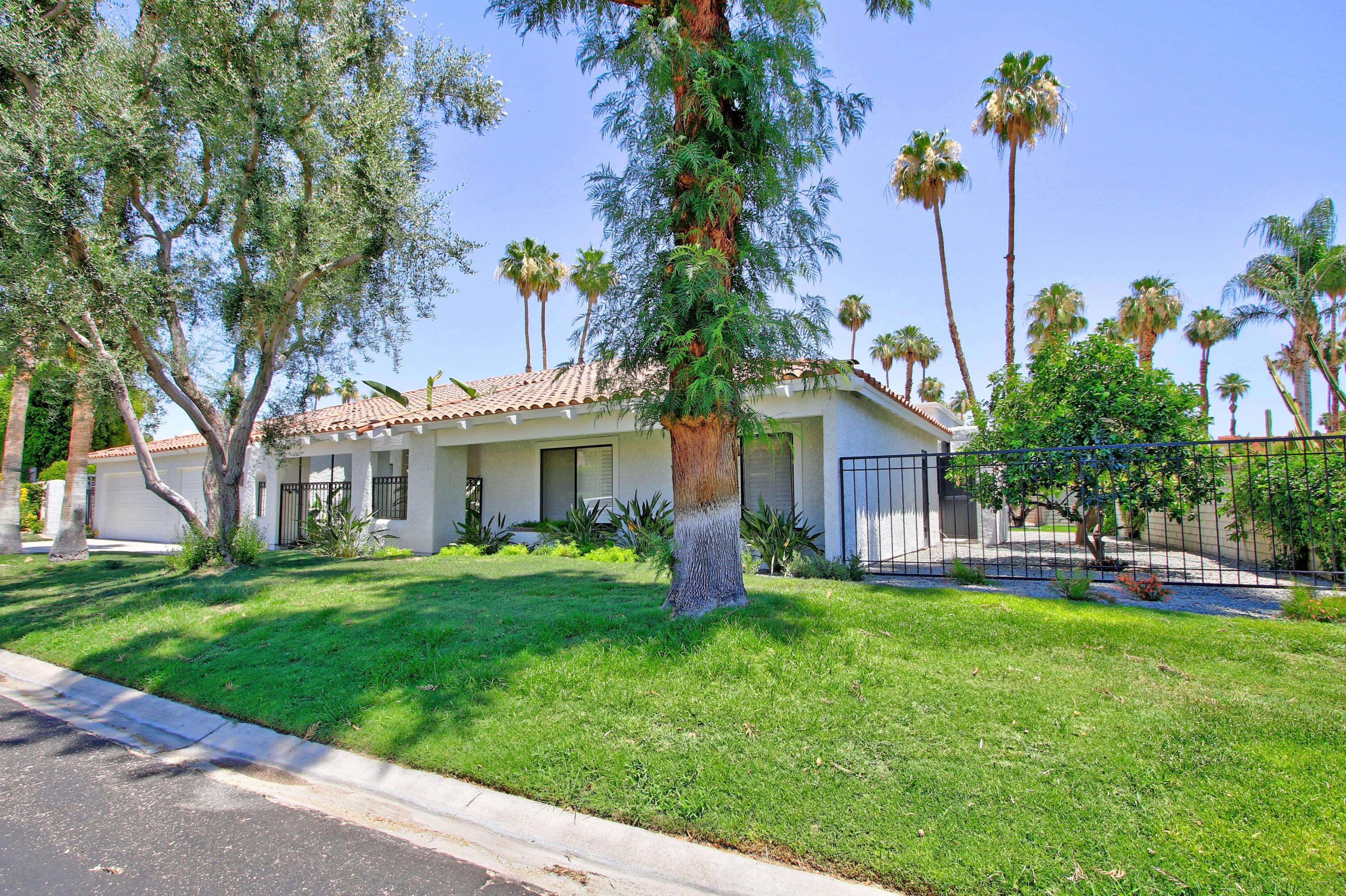 87 Magdalena Drive Rancho Mirage, CA 92270 - Photo 52 of 64 a front view of a house with a garden