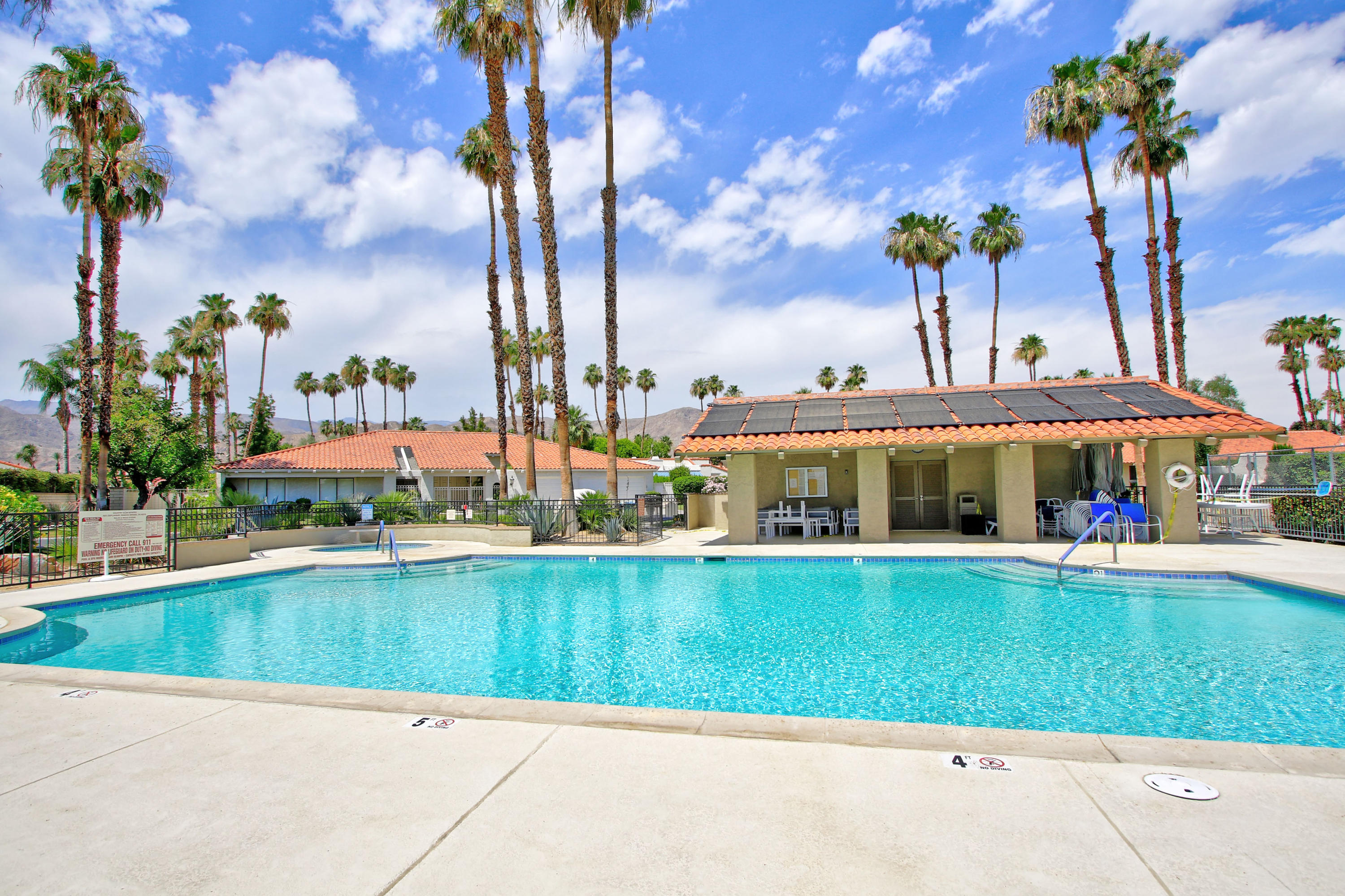 87 Magdalena Drive Rancho Mirage, CA 92270 - Photo 56 of 64 a view of a swimming pool with lawn chairs and a tables