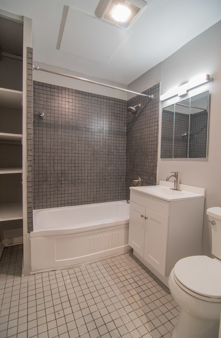 844 West Lakeside Place, Unit 1W Chicago, IL 60640 - Photo 11 of 14 a bathroom with a sink a toilet and shower