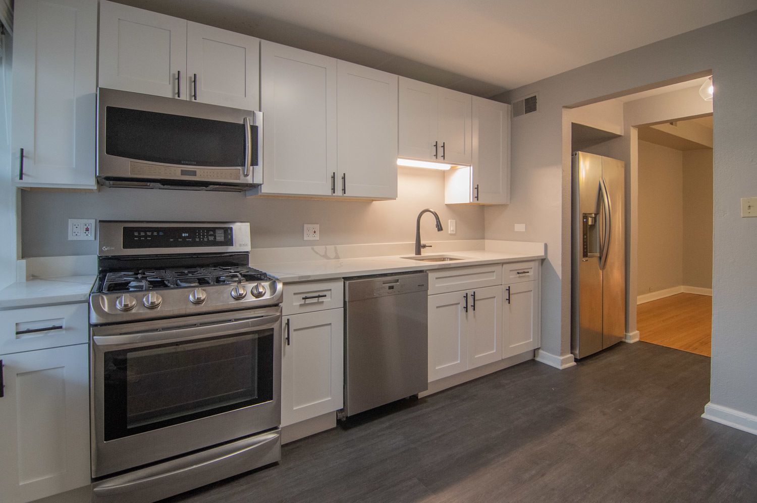 844 West Lakeside Place, Unit 1W Chicago, IL 60640 - Photo 4 of 14 a kitchen with stainless steel appliances a sink a stove and microwave