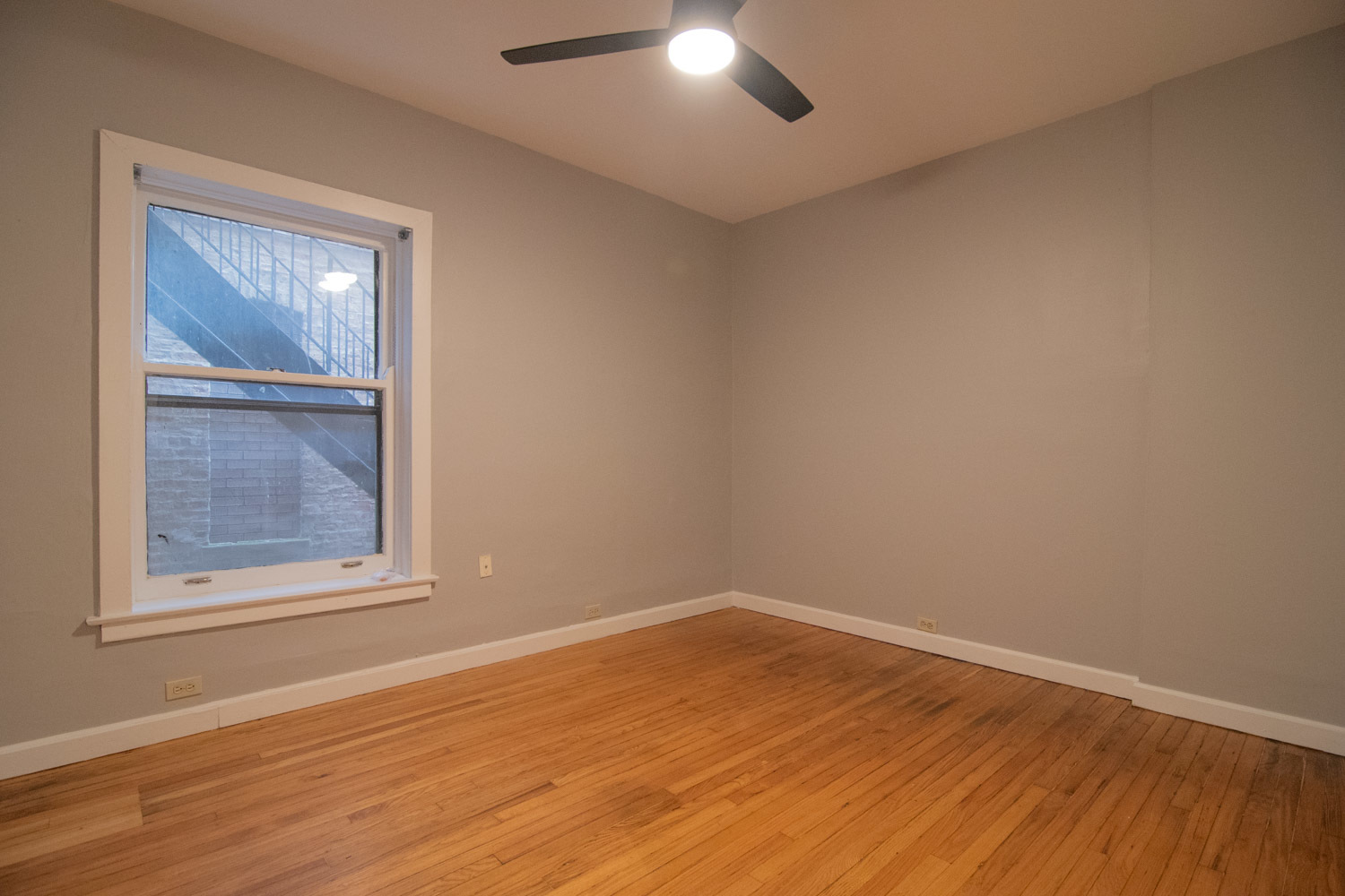 844 West Lakeside Place, Unit 1W Chicago, IL 60640 - Photo 8 of 14 a view of an empty room with wooden floor and a window