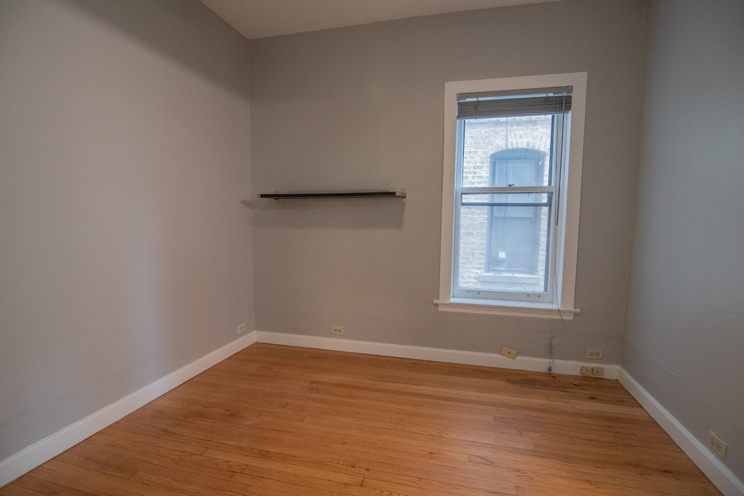 844 West Lakeside Place, Unit 1W Chicago, IL 60640 - Photo 9 of 14 a view of an empty room with wooden floor and a window