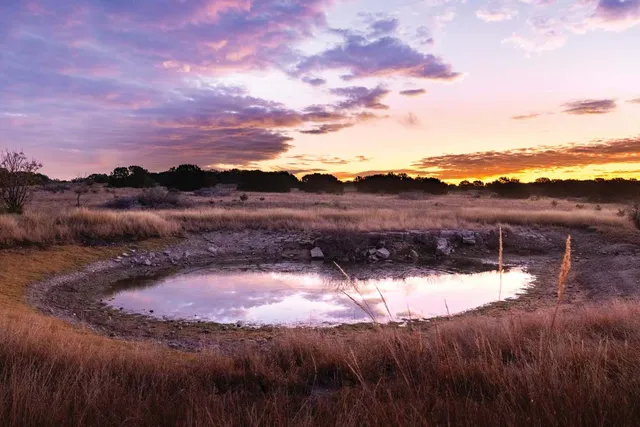 a view of a lake view with mountains in the background