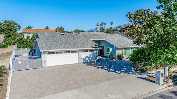 an aerial view of a house with yard and garage