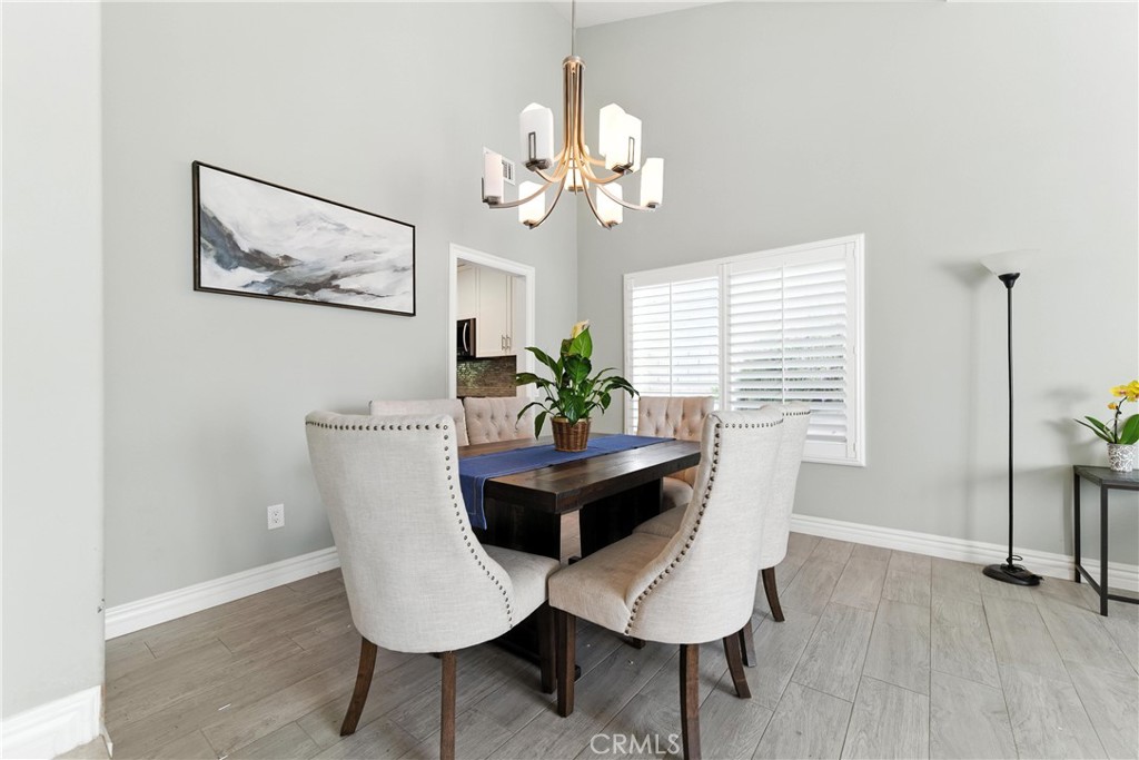 1817 Balboa Way Upland, CA 91784 - Photo 21 of 64 a dining room with wooden floor and a chandelier