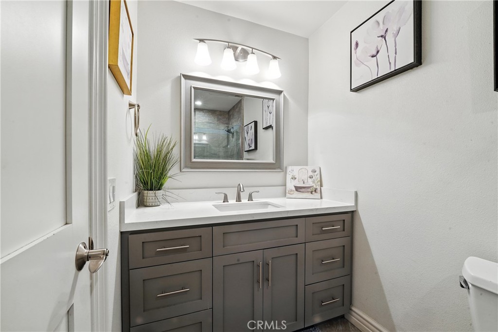 1817 Balboa Way Upland, CA 91784 - Photo 37 of 64 a bathroom with a toilet a sink and mirror