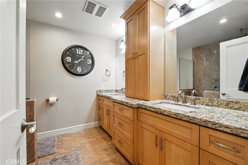 1817 Balboa Way Upland, CA 91784 - Photo 45 of 64 a bathroom with a granite countertop sink and a mirror
