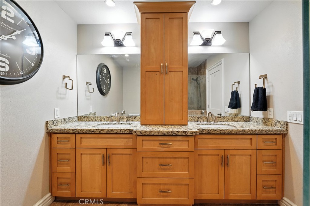 1817 Balboa Way Upland, CA 91784 - Photo 47 of 64 a bathroom with a granite countertop sink and a mirror