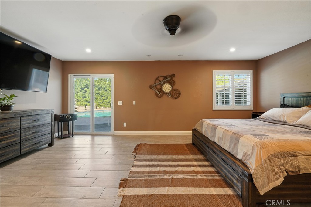 1817 Balboa Way Upland, CA 91784 - Photo 48 of 64 a spacious bedroom with a large bed and a flat screen tv