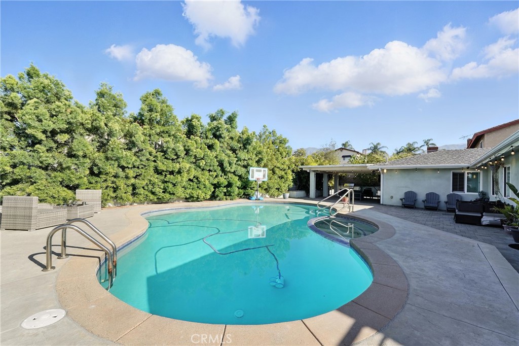 1817 Balboa Way Upland, CA 91784 - Photo 57 of 64 a view of a swimming pool with lawn chairs and potted plants