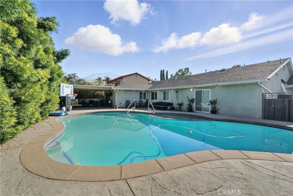 1817 Balboa Way Upland, CA 91784 - Photo 58 of 64 a view of a white house with a swimming pool and a fire pit